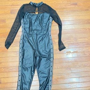 Bebe black polyurethane and sheer logo jumpsuit.